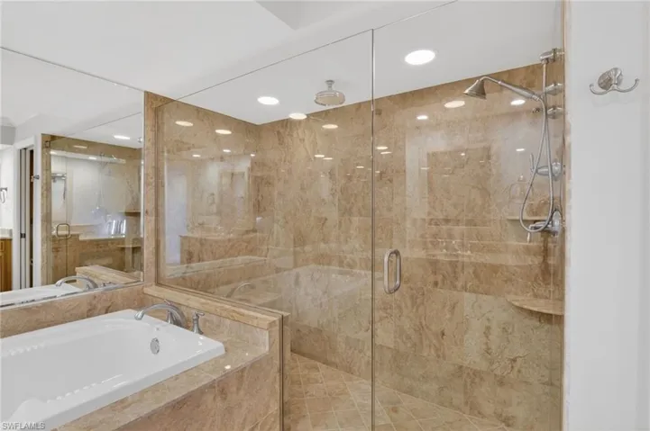 Bathroom with a garden tub, a shower stall, recessed lighting, and vanity