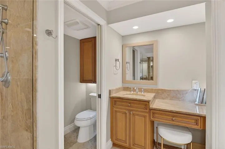 Full bath with vanity, a stall shower, light tile patterned floors, and recessed lighting