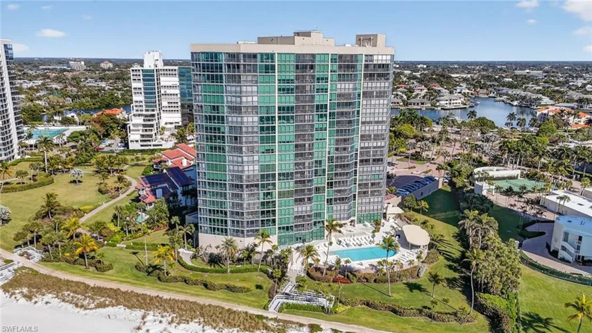 Bird's eye view of a pool area and a nearby body of water