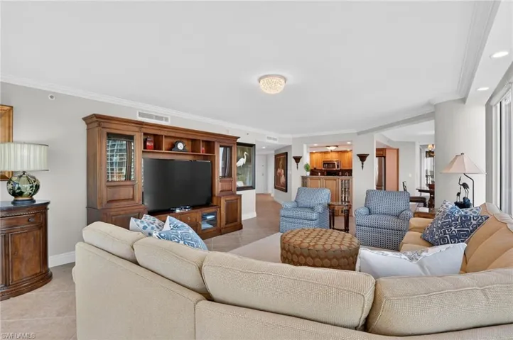 Living area featuring ornamental molding, light tile patterned floors, and recessed lighting