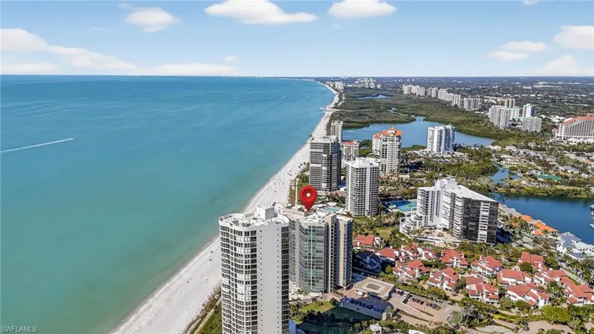 View of urban area featuring waterfront with a beach