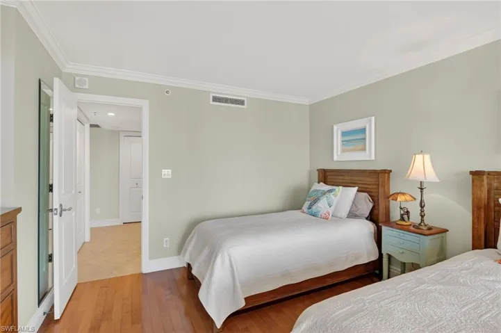 Bedroom featuring crown molding and hardwood / wood-style floors