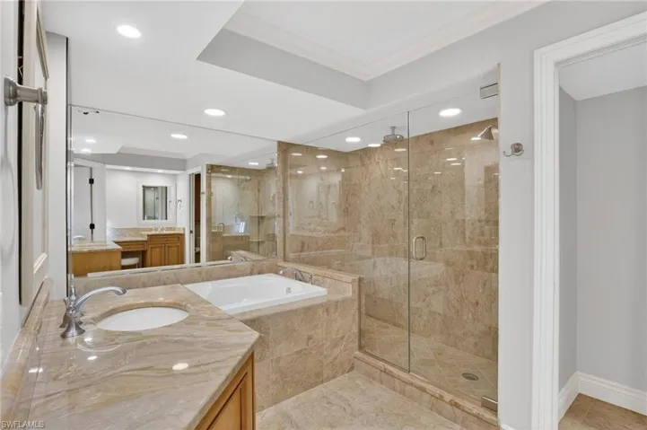 Full bathroom featuring vanity, a shower stall, a bath, ornamental molding, and recessed lighting