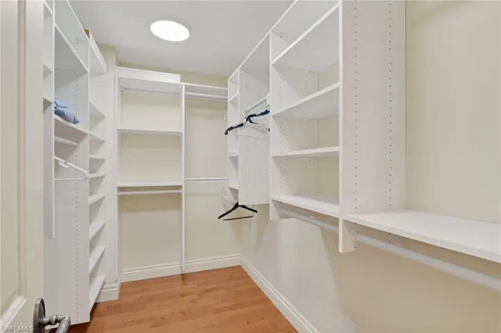 Walk in closet featuring light wood-style flooring