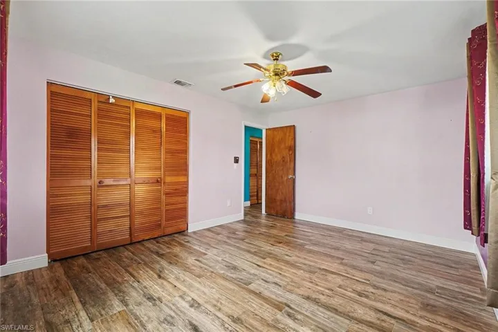 A lovely pink hue is a great accent to this bedroom