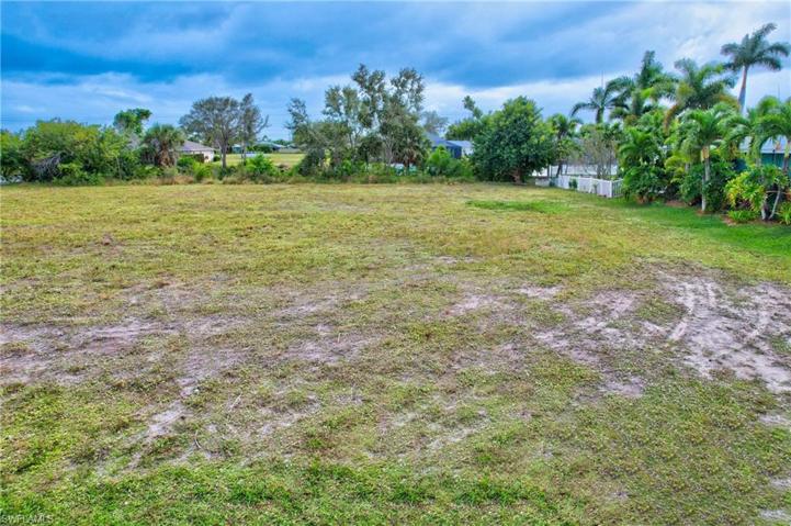 Ground level view. Canal behind. Cleared lot.