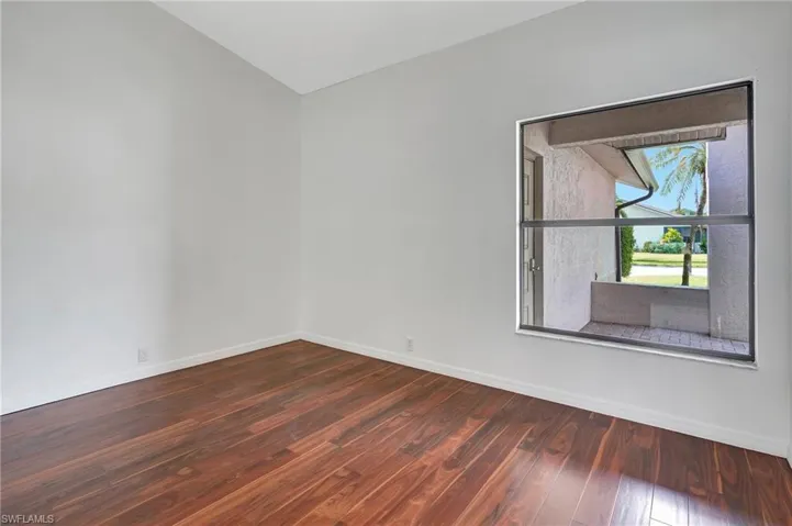 Empty room featuring dark wood-type flooring