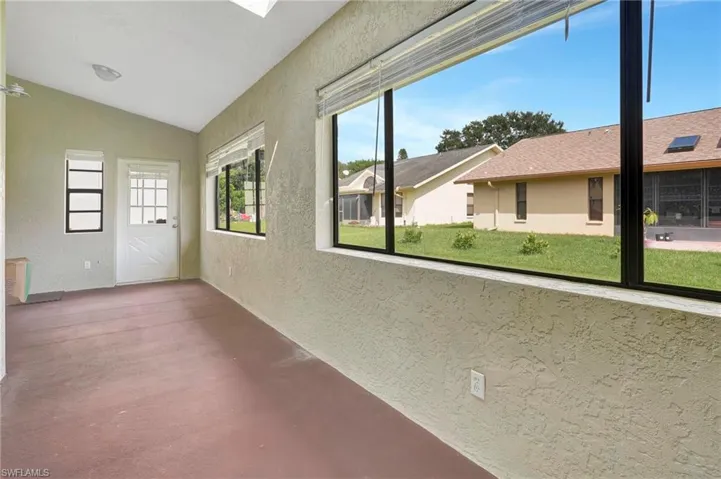Unfurnished sunroom featuring vaulted ceiling