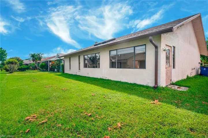 Back of property featuring a yard