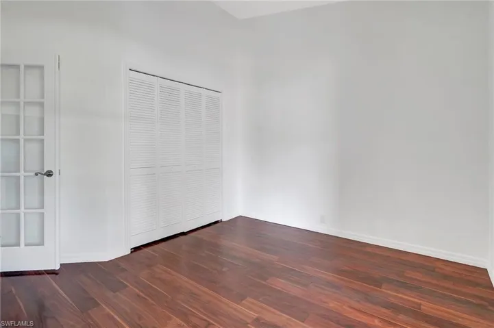 Spare room with dark hardwood / wood-style flooring