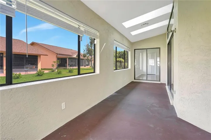 Hall with lofted ceiling with skylight