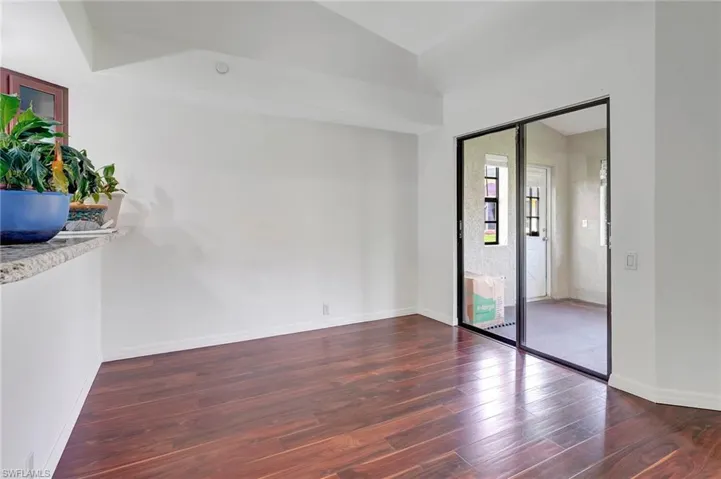 Empty room featuring dark wood-type flooring