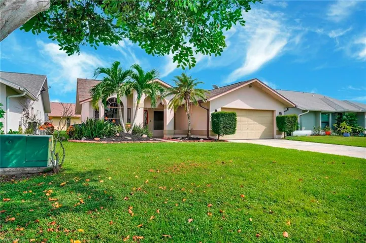 View of front of house featuring a garage and a front yard