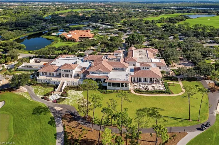 Aerial perspective of suburban area featuring a large body of water and a golf club