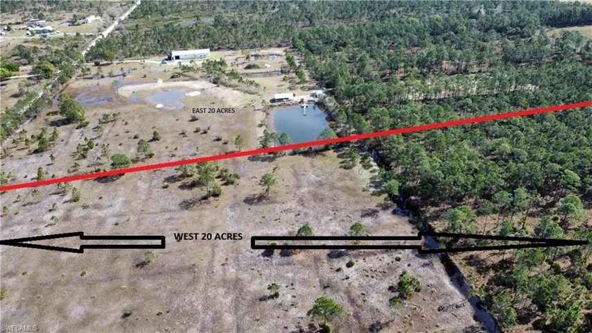 Birds eye view of property featuring a forest view