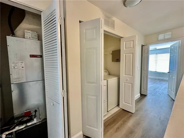 View of the seamless flooring second floor hallway with bifolds to NEW A/C CHANGEOUT utility and linen closet open