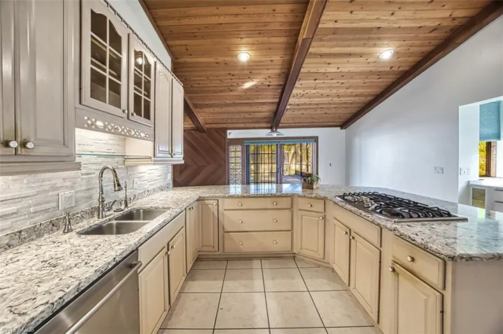 Quartz countertops, tiled backsplash and counter Gas range!