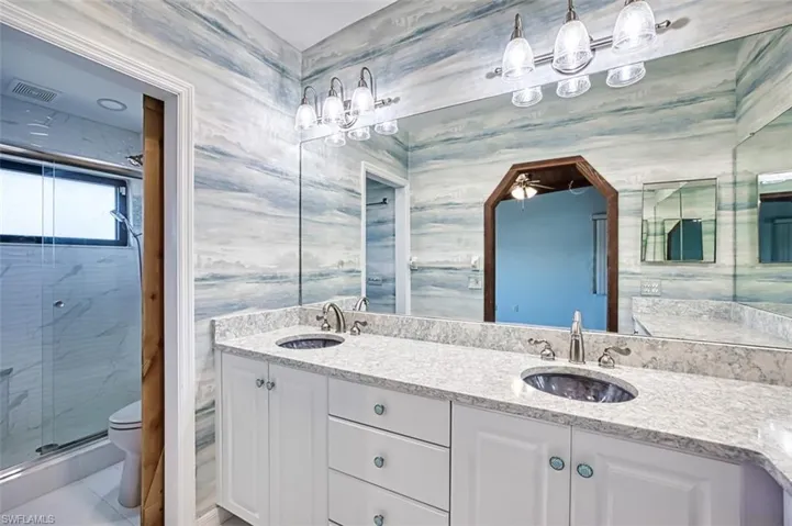 Primary Bath features dual glass sinks and Tiled walk-in Shower