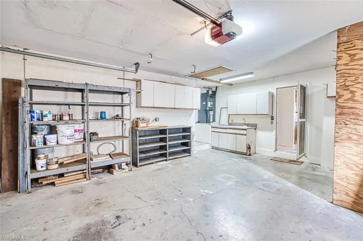 Oversized garage has storage shelving and work sink. shelving