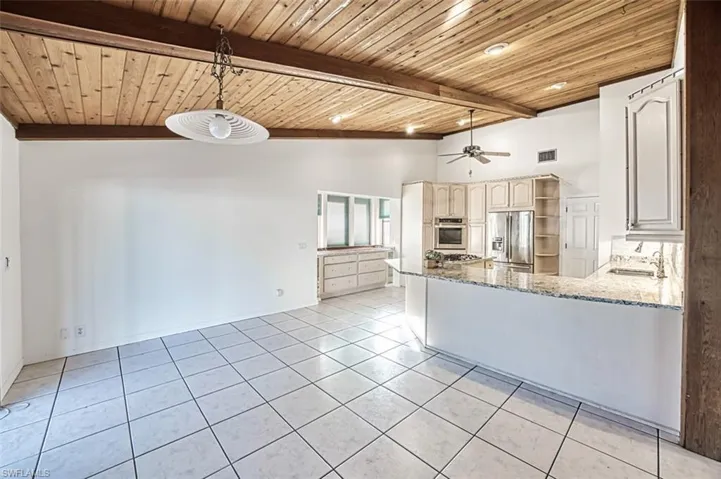 Kitchen opens to the Dining area with views and entry to the pool.