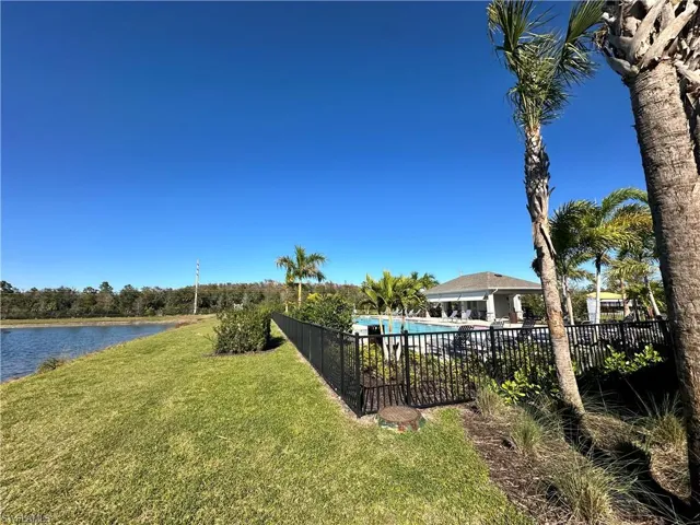 View of yard with a water view and a community pool