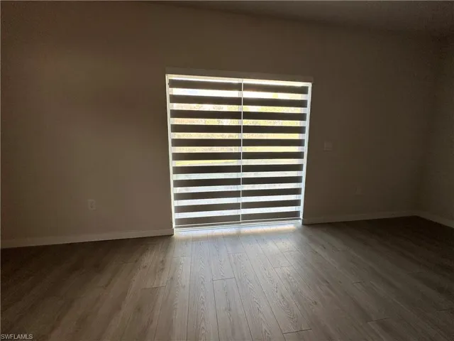 Empty room with wood finished floors and baseboards