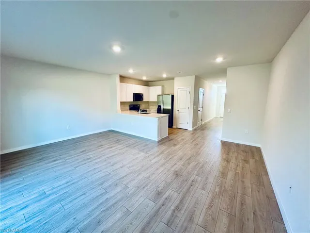 Unfurnished living room featuring light wood-style flooring and recessed lighting