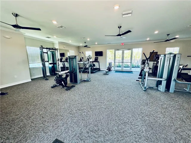 Gym with crown molding, ceiling fan, french doors, and recessed lighting