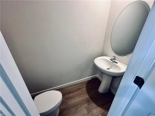 Bathroom with baseboards and wood finished floors