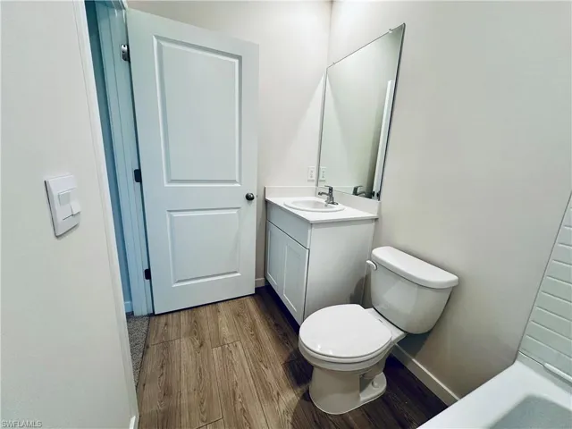 Bathroom featuring vanity and dark wood-type flooring