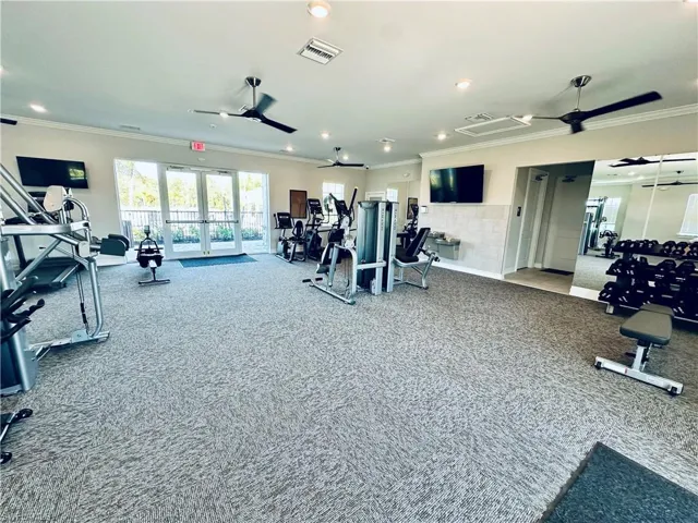 Workout area with a ceiling fan, crown molding, french doors, and recessed lighting