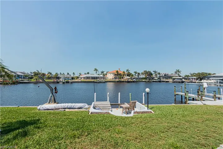 Dock area featuring a yard, a water view, and a residential view