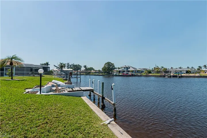 Dock area featuring a yard and a water view