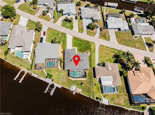 View of property location with nearby suburban area and a nearby body of water