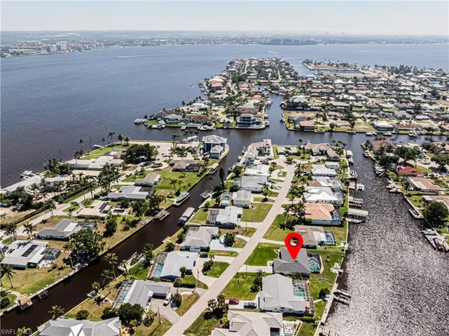 Aerial perspective of suburban area featuring a nearby body of water