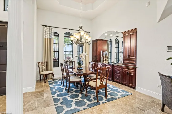 An expansive dining room with built in buffet and soaring ceilings with crown molding and tray ceiling - its all about the details!