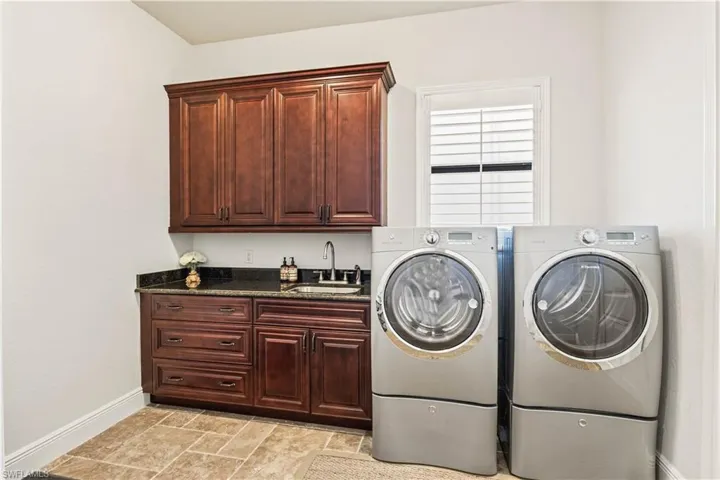 Laundry room off the garage - just like everything else in the home, this is loaded with extras - oversized, large pantry with double doors, laundry sink and plenty of room to add storage.