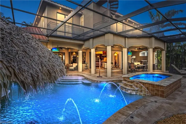 WOWZA! A view looking towards the home - all boxes checked here - tiki hut, outdoor kitchen, multiple lounging areas, ten person spa, everything you need to enjoy a lifetstyle loaded with amenities.