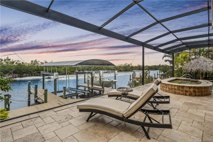 Facing the Spreader Canal that leads directly out to open waters and with views of the preserve that will never be developed.  Large sunning areas and picture window pool cage to maximize the outdoor views with no obstruction!