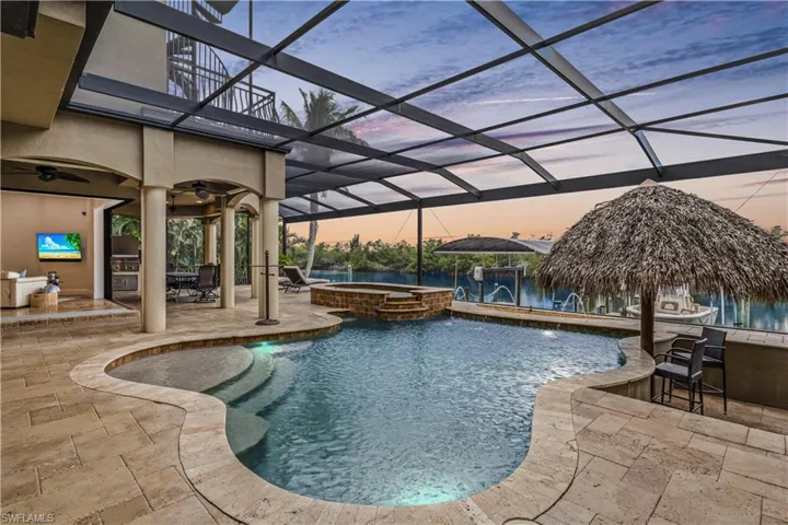 Living room doors are open and expanded to the outdoor area - maximizing the views, the living space and the vibrancy of the sunsets and waters!