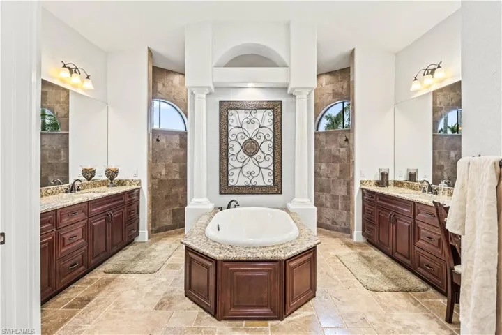 A spa like retreat with his and hers vanities with a garden tub and double entry shower with multiple heads!  There is so much counterspace - a work of art that is both functional and beautiful!  Two large walk in closets are located between the bathroom and bedroom and offer plenty of space for large wardrobes!