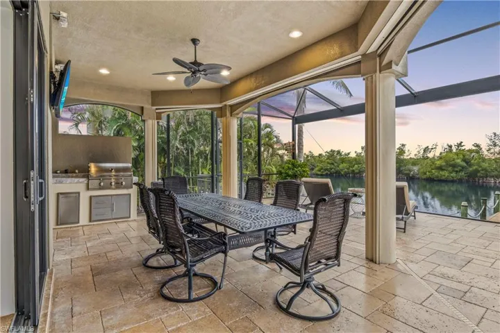 Relax and enjoy the outdoor lifestyle - west facing for glorious sunsets that will take your breathe away!  Outdoor kitchen and dining area with automated roll down sun shades and a large screened in pool area!