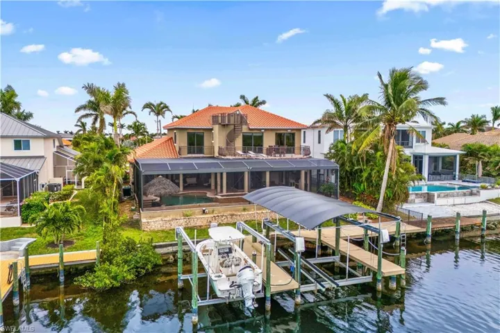Are you a boater?  If so, you will LOVE what this home has to offer for you!  TWO boatlifts - one that is 20k and one is 10k pound lifts - this is direct access and can also be easily reconfigured to house a 55 foot yacht - deep water and a wide canal is a double win!
