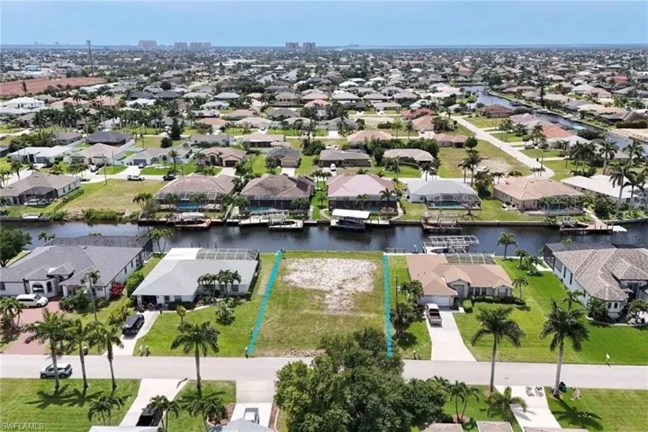 Aerial view of property and surrounding area with property boundaries highlighted and a large body of water