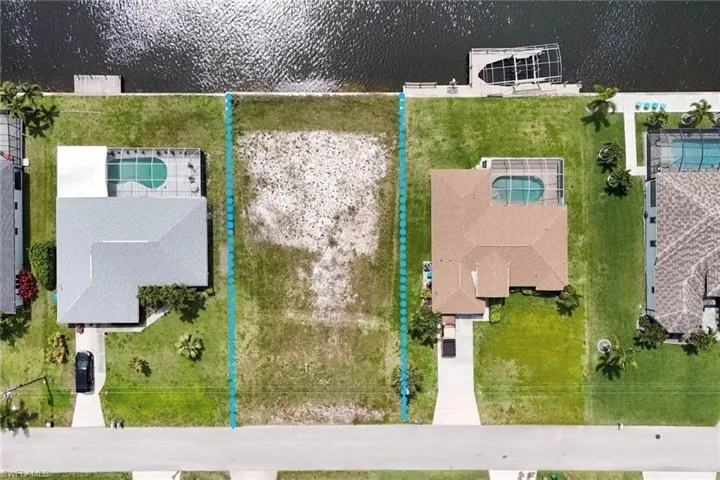 Aerial perspective of suburban area with a nearby body of water