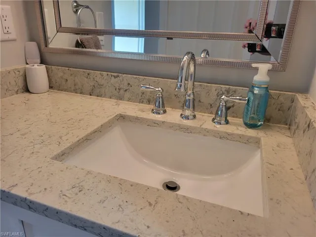 Updated master vanity with new quartz counter, mirror and faucets