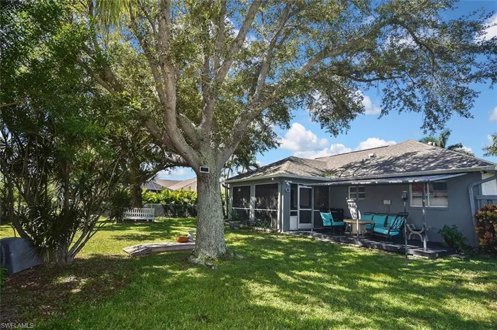 View of yard featuring a sunroom and a patio area