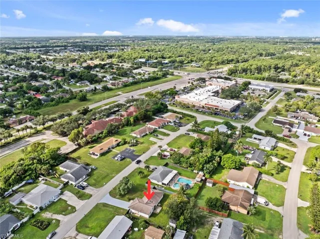 Residential area with green landscaping and surrounding commercial properties