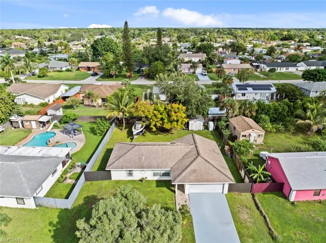Single-story residence featuring a shingled roof, attached garage, and a concrete driveway