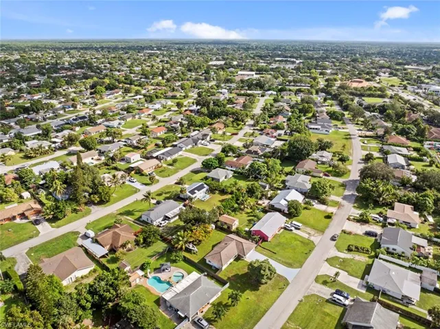 Residential neighborhood with a mix of single-story homes, mature trees, and paved streets